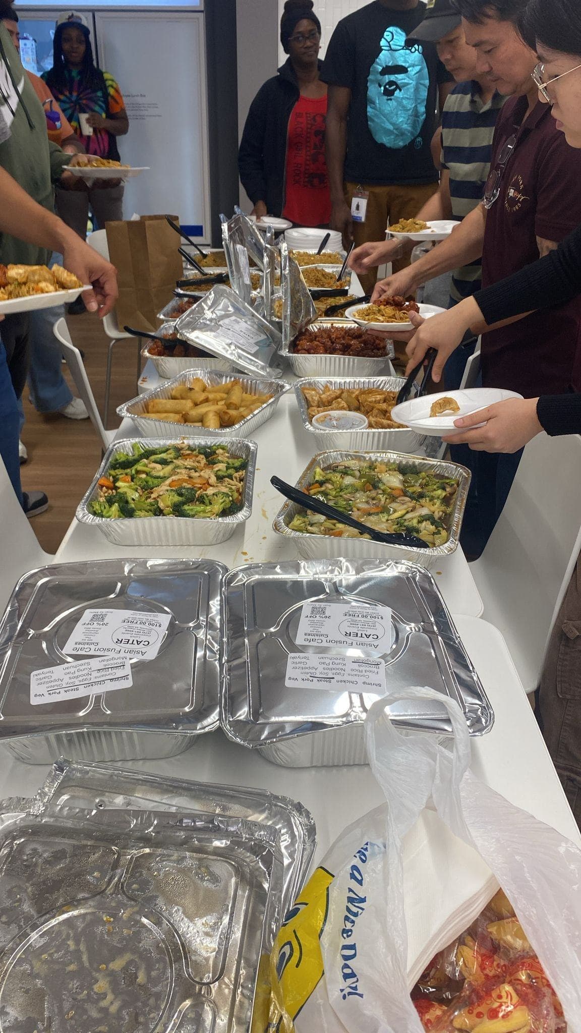 Guests serving themselves from a General Tso's catering buffet