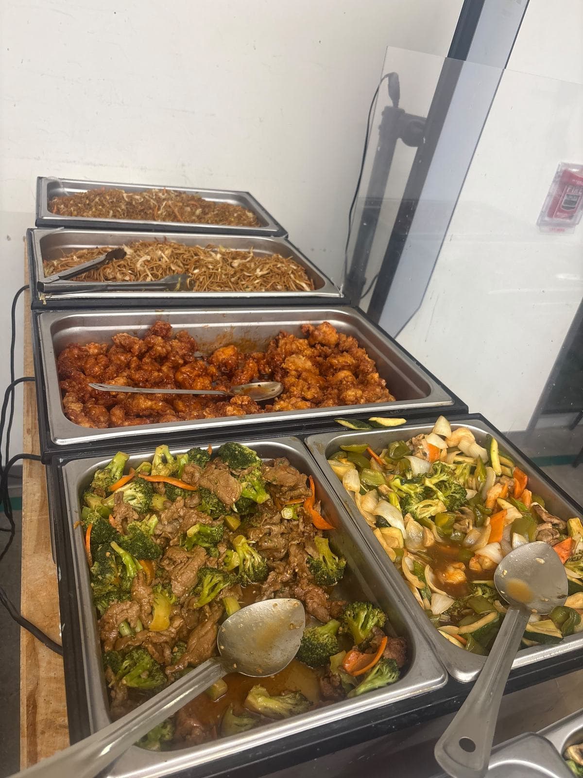 Hot buffet of Chinese food in chafing dishes set up for an Atlanta office