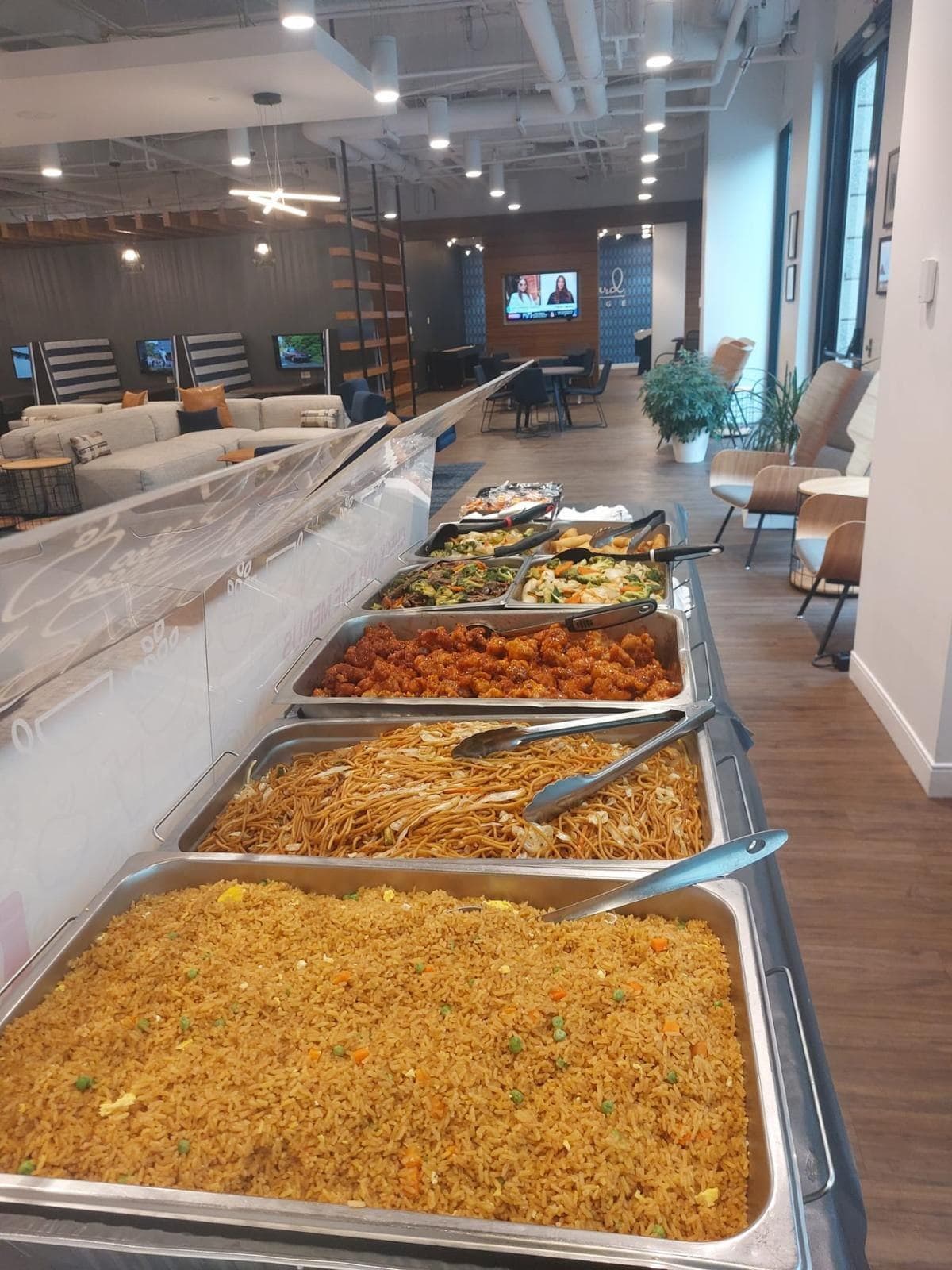 Office buffet line with fried rice, lo mein and entrées from General Tso's Catering