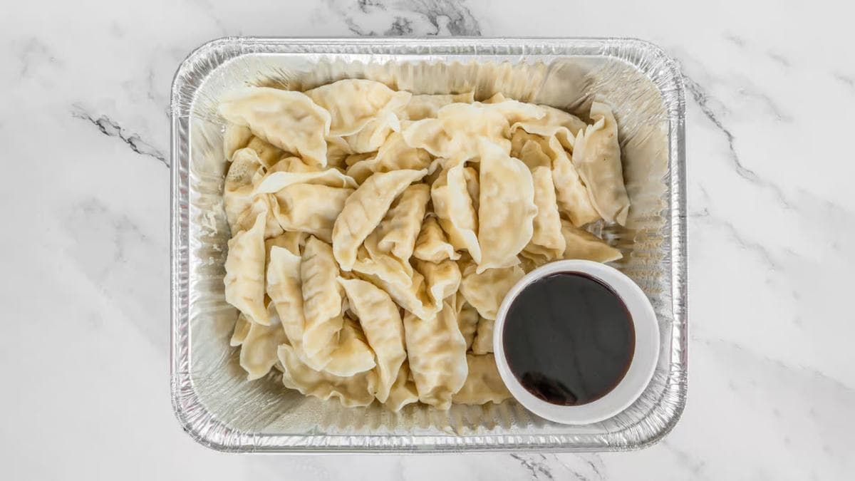 Catering tray of potstickers with dipping sauce