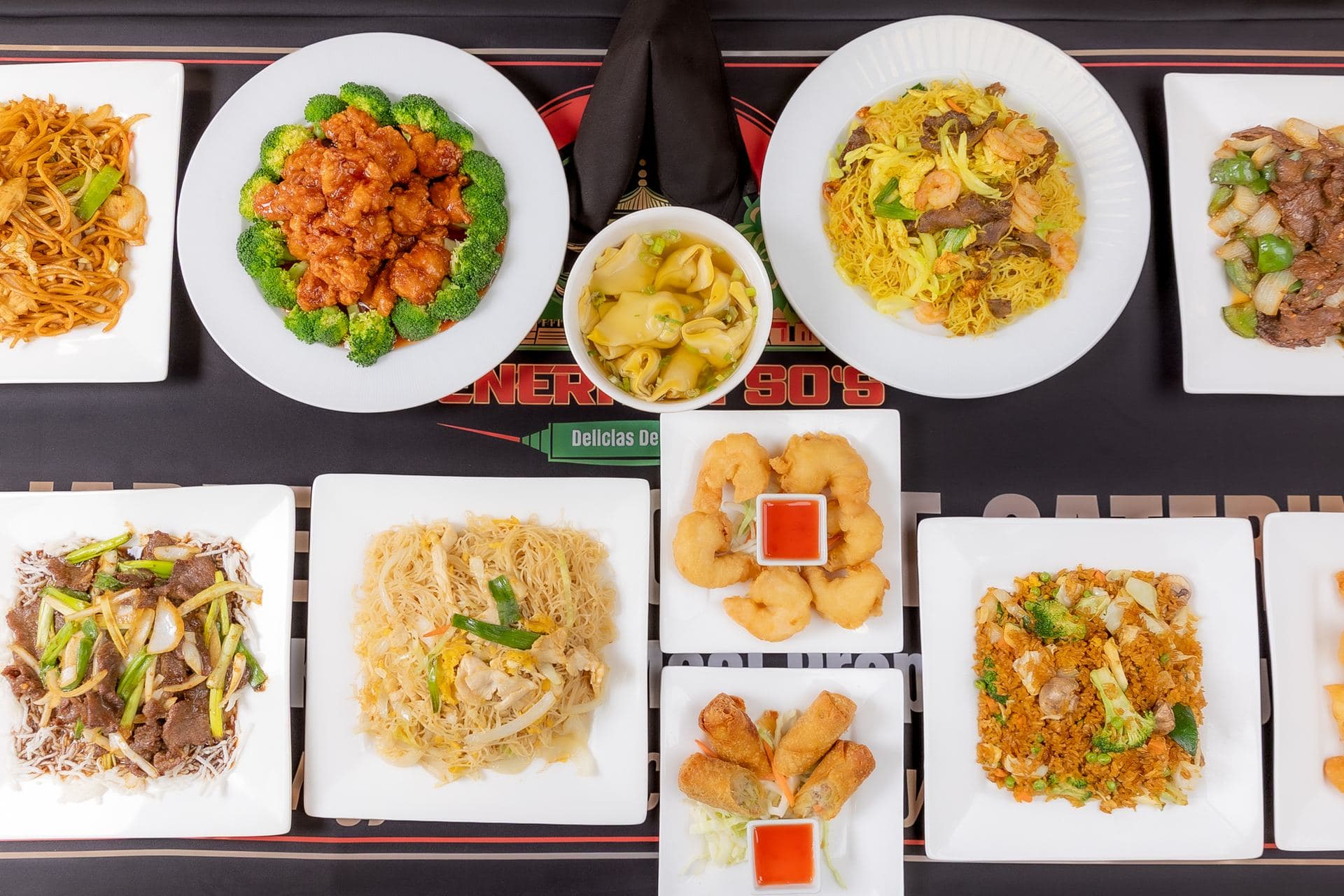 Overhead spread of General Tso's Chinese catering — lo mein, fried rice, crab rangoons, spring rolls and entrées